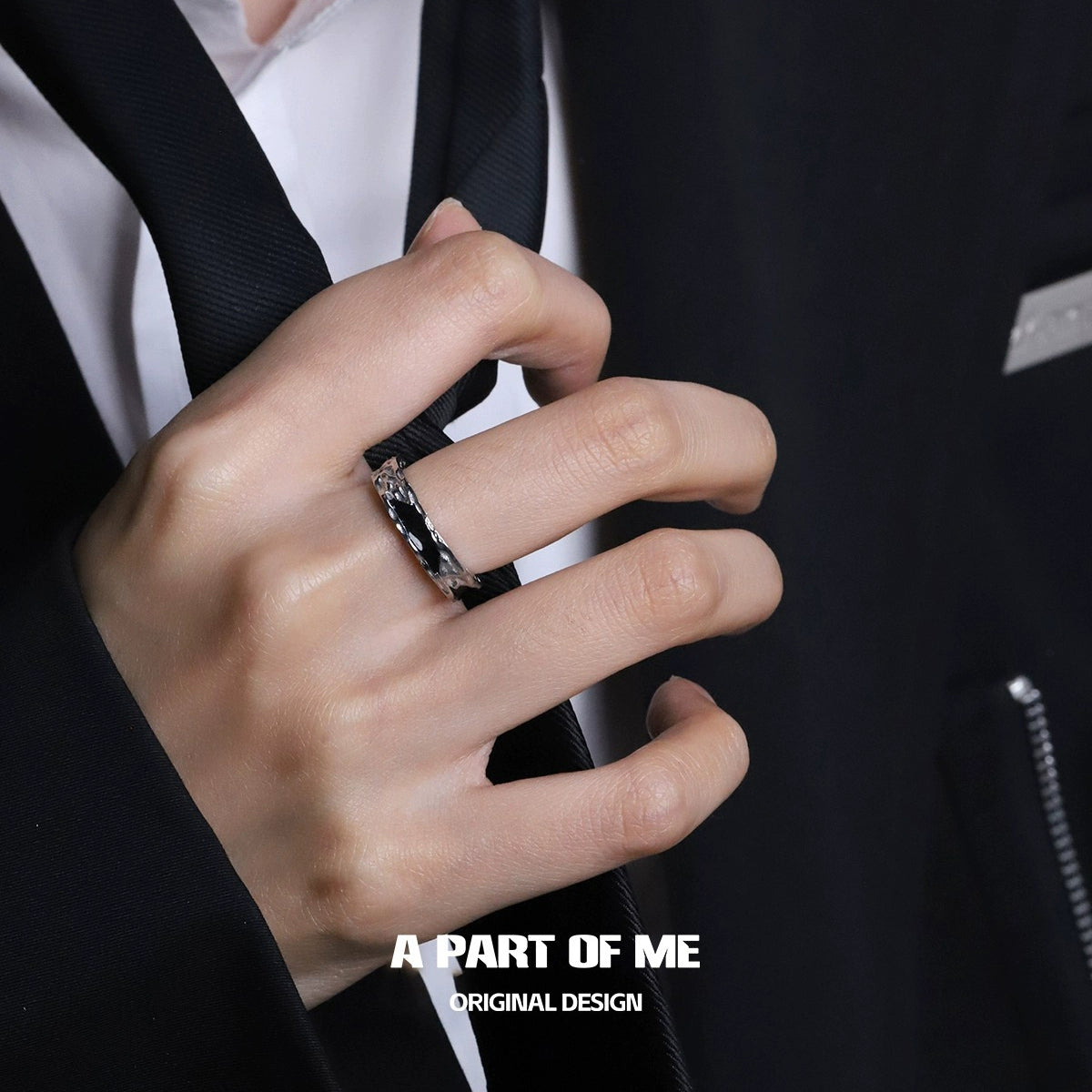 A PART OF ME dark hills ring worn on a hand with a formal attire for a stylish look