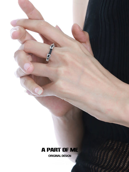Elegant A PART OF ME dark matter ring showcased on a model's hand with natural nails