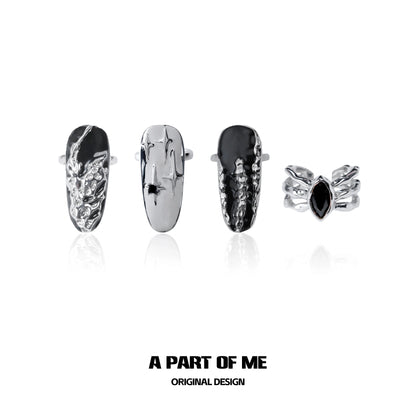 Set of four A PART OF ME dark queen finger guard rings featuring unique metallic designs