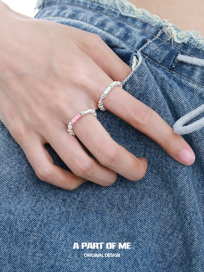 Two A PART OF ME dopamine rings stacked on a hand with denim shorts for a trendy look