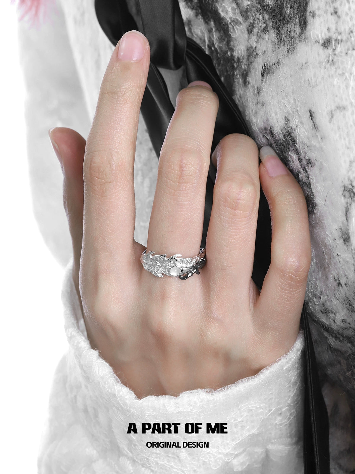 Silver feather letter ring worn on a hand, showcasing an elegant design for personalized style
