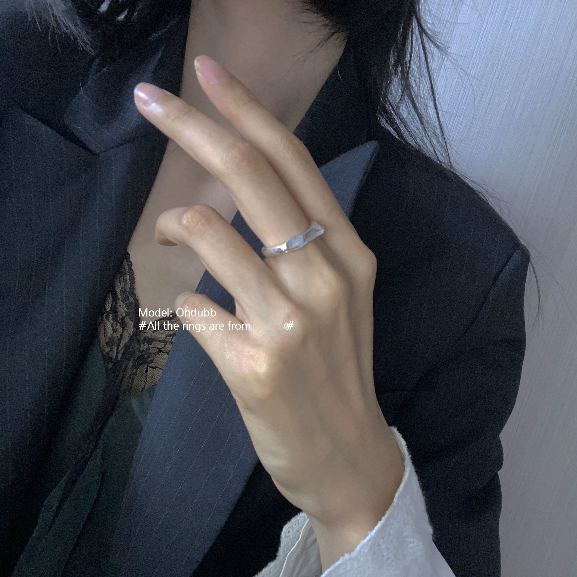Elegant geometric star ring worn on a model's finger, showcasing its unique design and shine