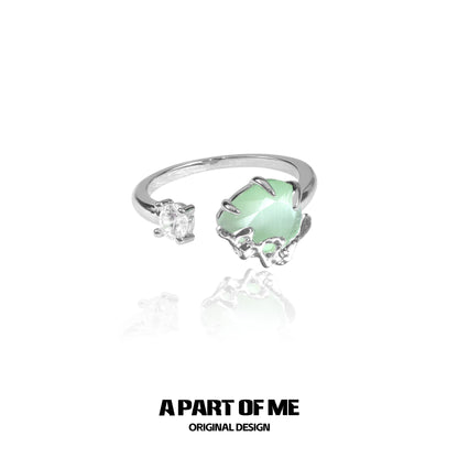 Elegant green opal ring with unique silver band design and sparkling accents