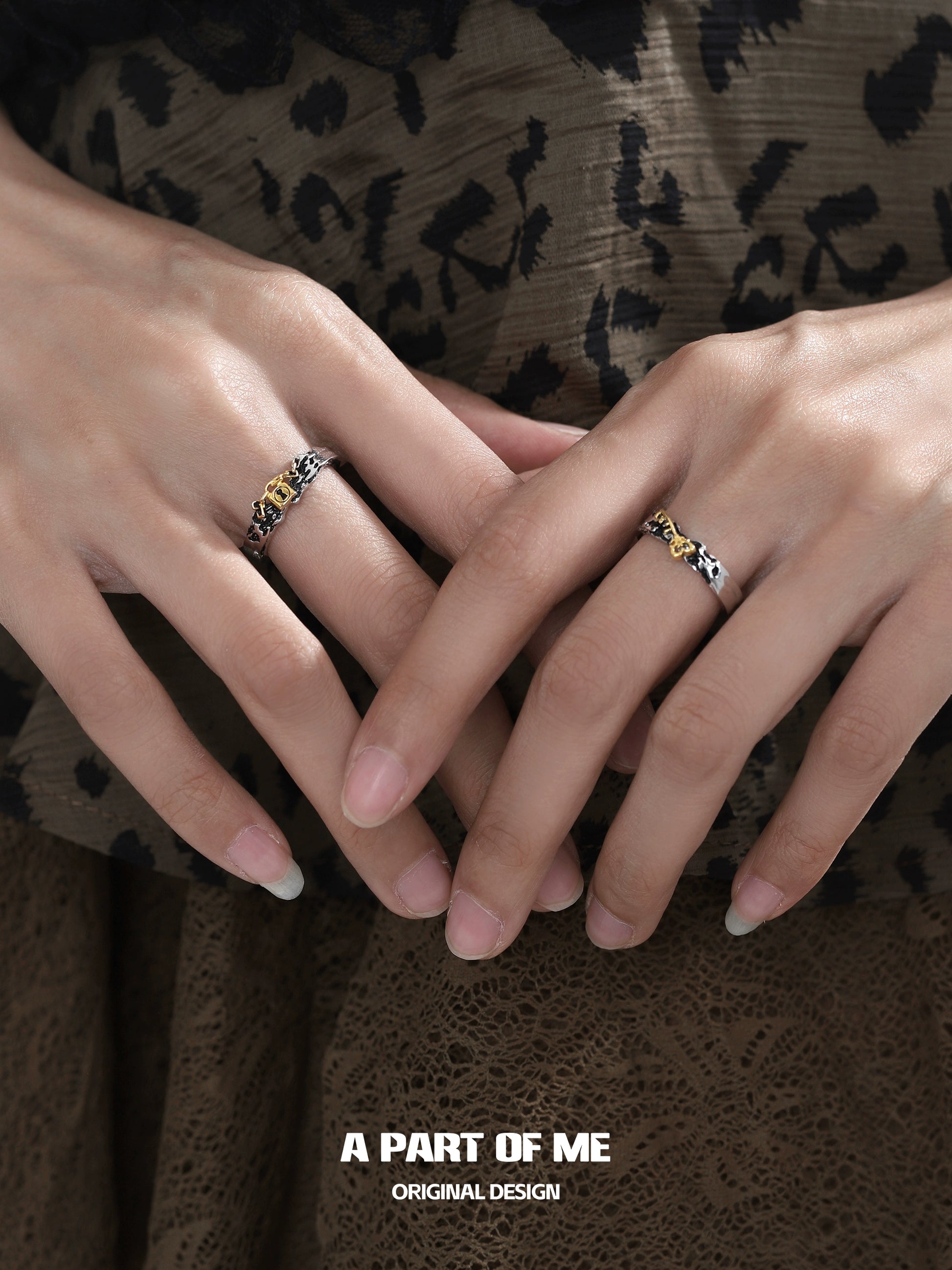 Stylish A PART OF ME hell lock ring displayed on two hands with elegant design