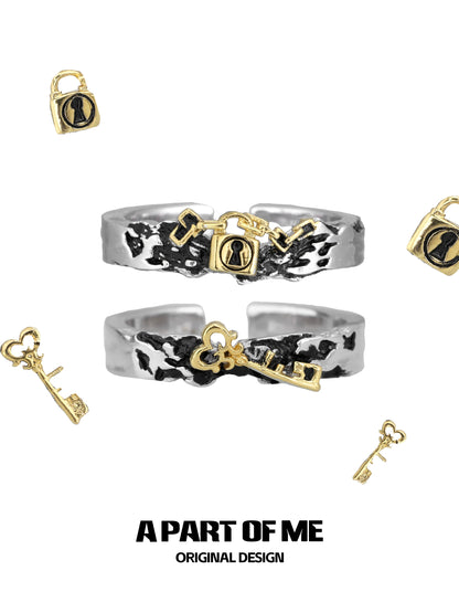 A PART OF ME hell lock ring featuring a unique design with key and padlock motifs in silver and gold