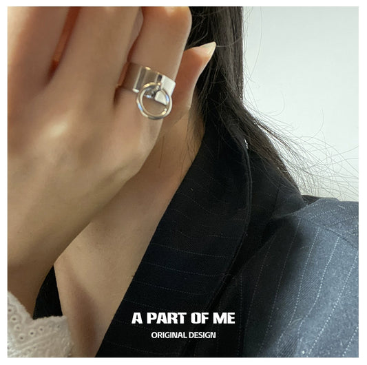 A PART OF ME hip hop pull tab ring worn on finger with stylish outfit in close-up view