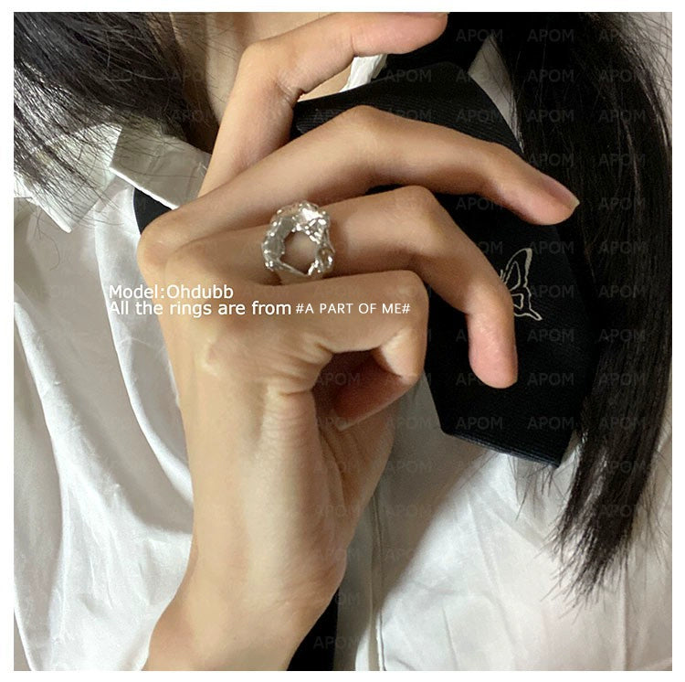 Woman wearing an imperfect beauty silver ring, showcasing its unique design and trendy style.