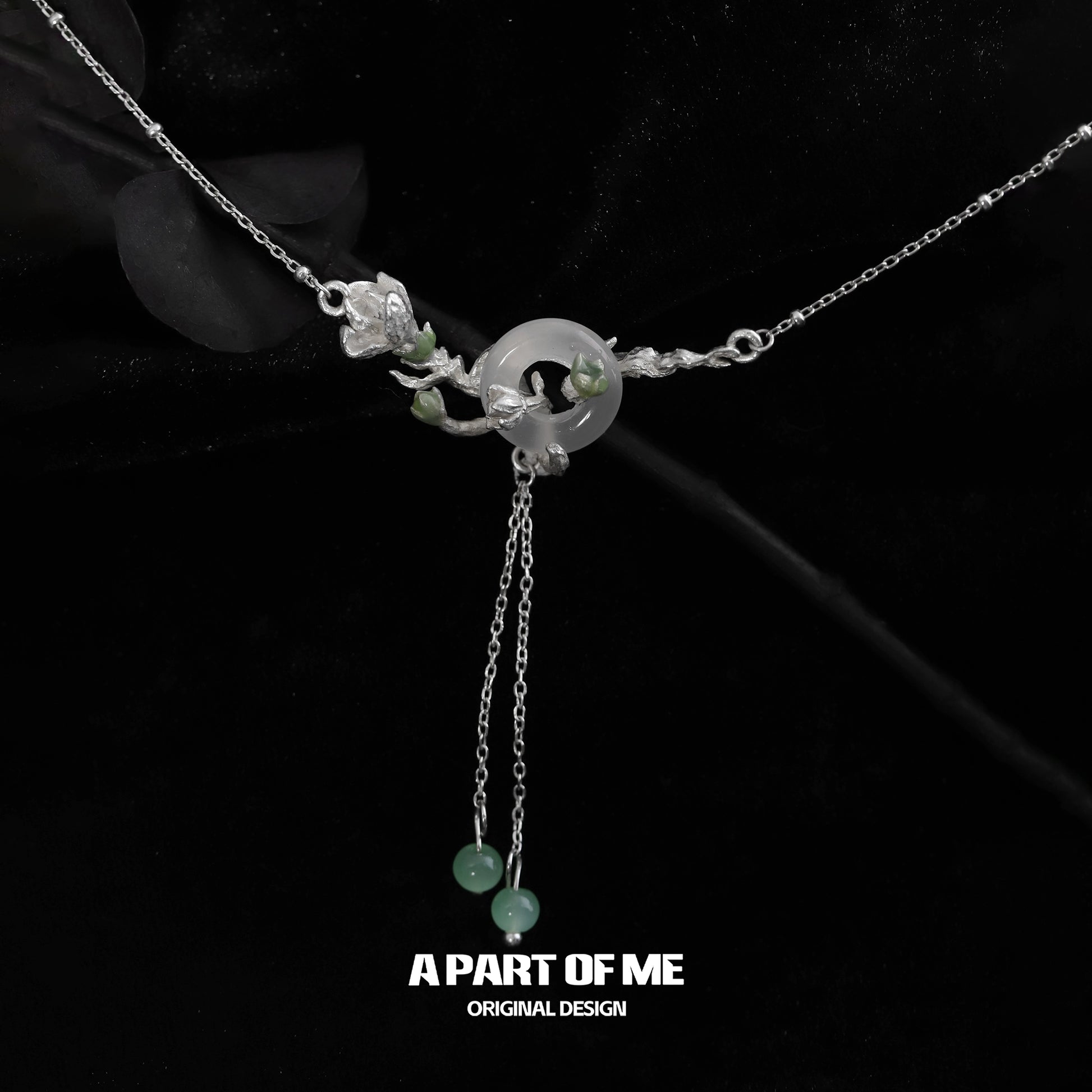 Jasmine silver necklace featuring intricate floral design and jade accents for elegant style