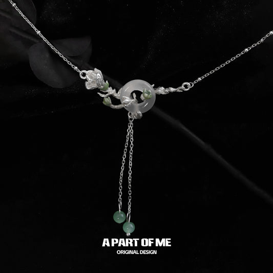 Jasmine silver necklace featuring intricate floral design and jade accents for elegant style