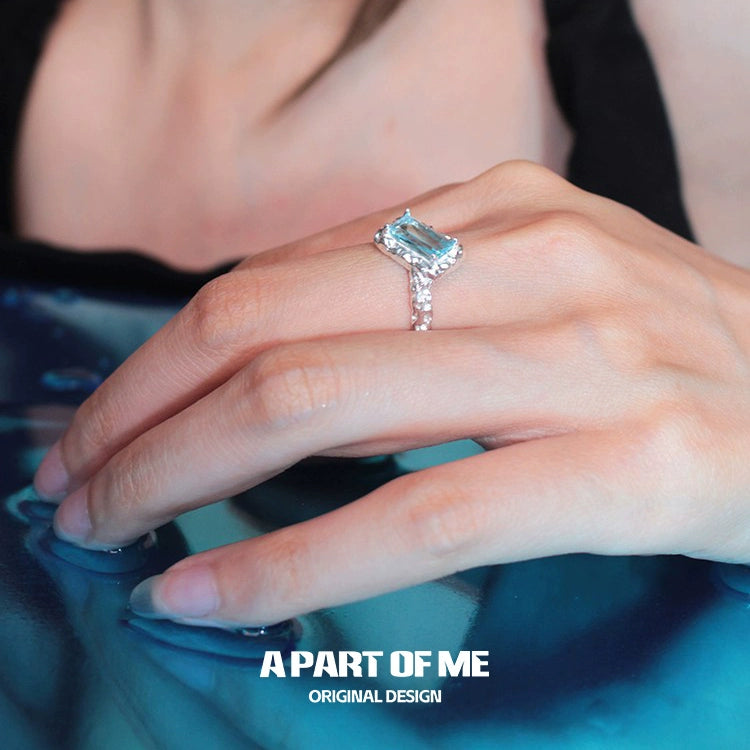 Elegant A PART OF ME mermaid tears silver ring with a sparkling blue gemstone, worn on a hand