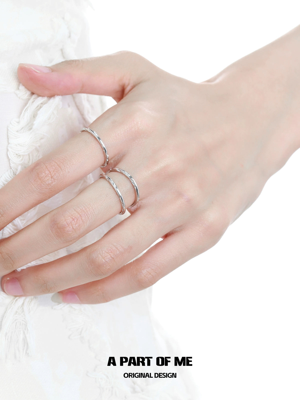 Close-up of minimalist stack rings worn on fingers for a stylish, modern look by A PART OF ME