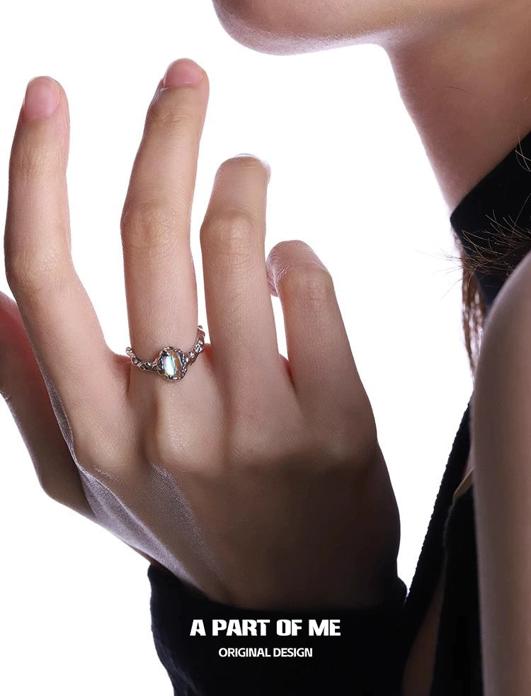 Elegant moonstone silver ring showcased on a hand with a stylish black background