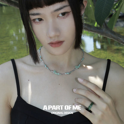 Fashion model wearing an opal anchor necklace highlighting its elegant design and gemstone details