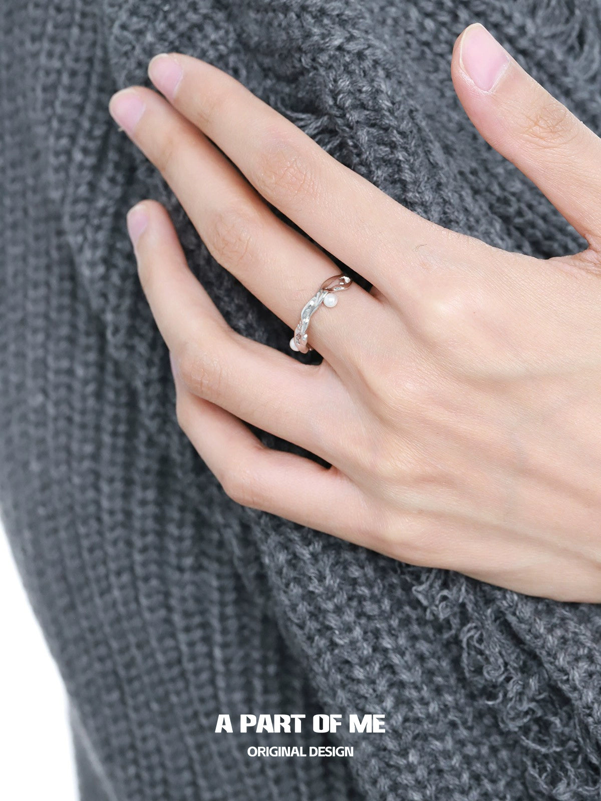 A PART OF ME pearl statement ring displayed on a hand with a cozy gray sweater
