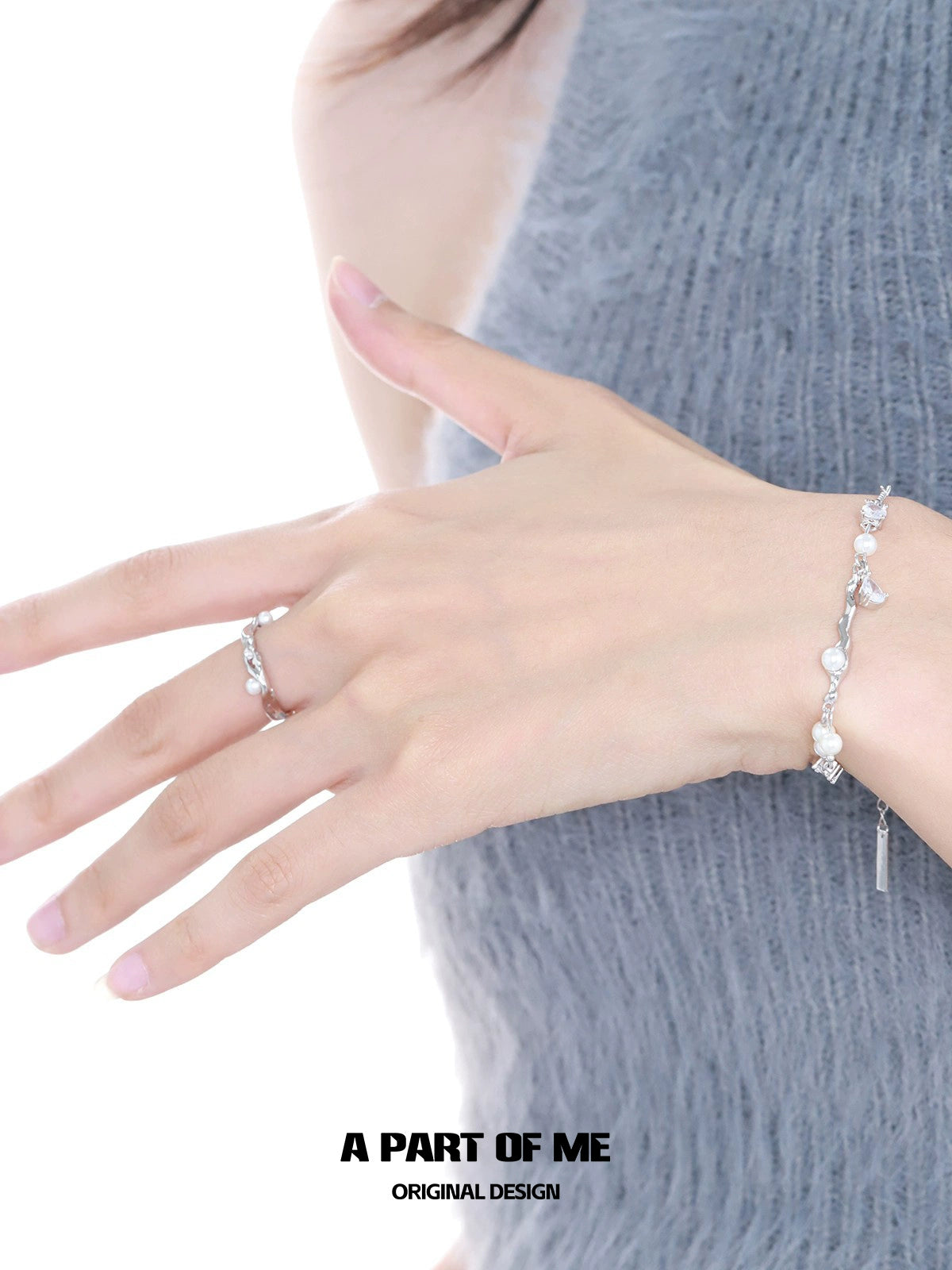 A PART OF ME pearl statement ring worn elegantly on a hand with a delicate bracelet