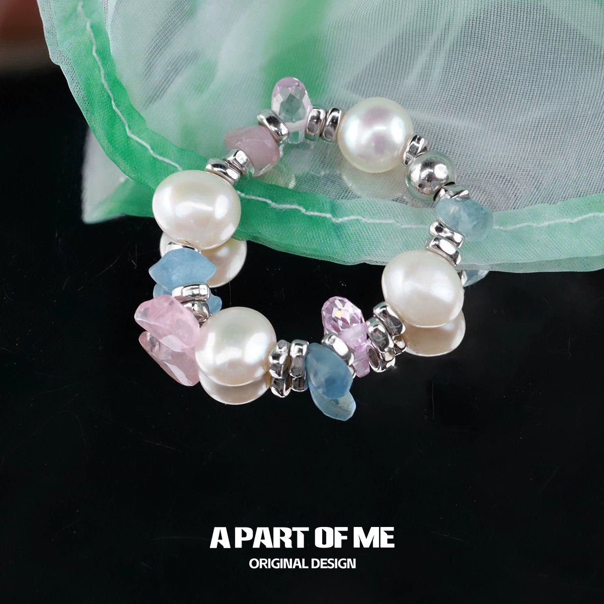 A rainbow pearl ring featuring colorful gemstones and silver accents for a vibrant look