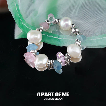 A rainbow pearl ring featuring colorful gemstones and silver accents for a vibrant look
