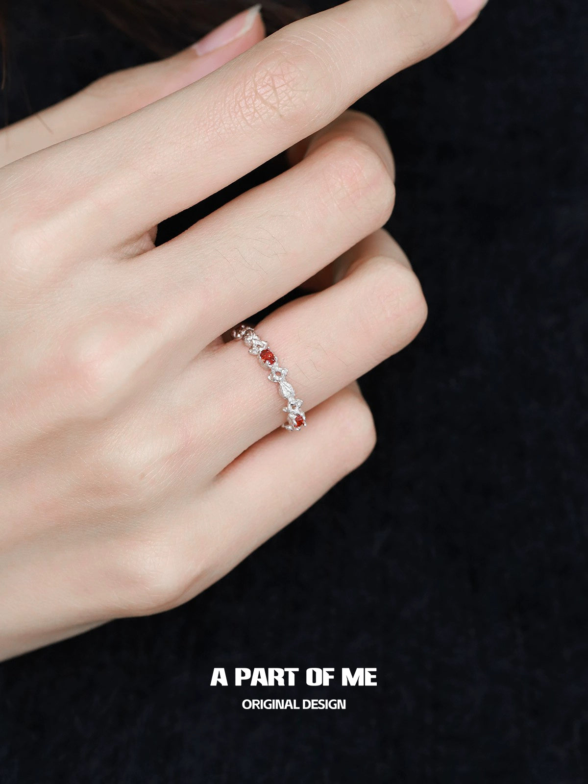 A PART OF ME red candy ring with colorful stones on a silver band worn on a hand
