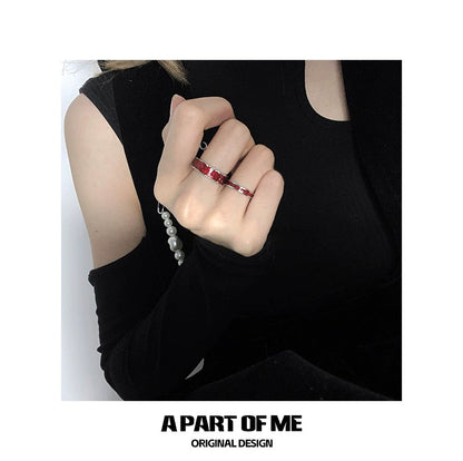 Stylish red venom couple rings displayed on a model's hand with a chic outfit