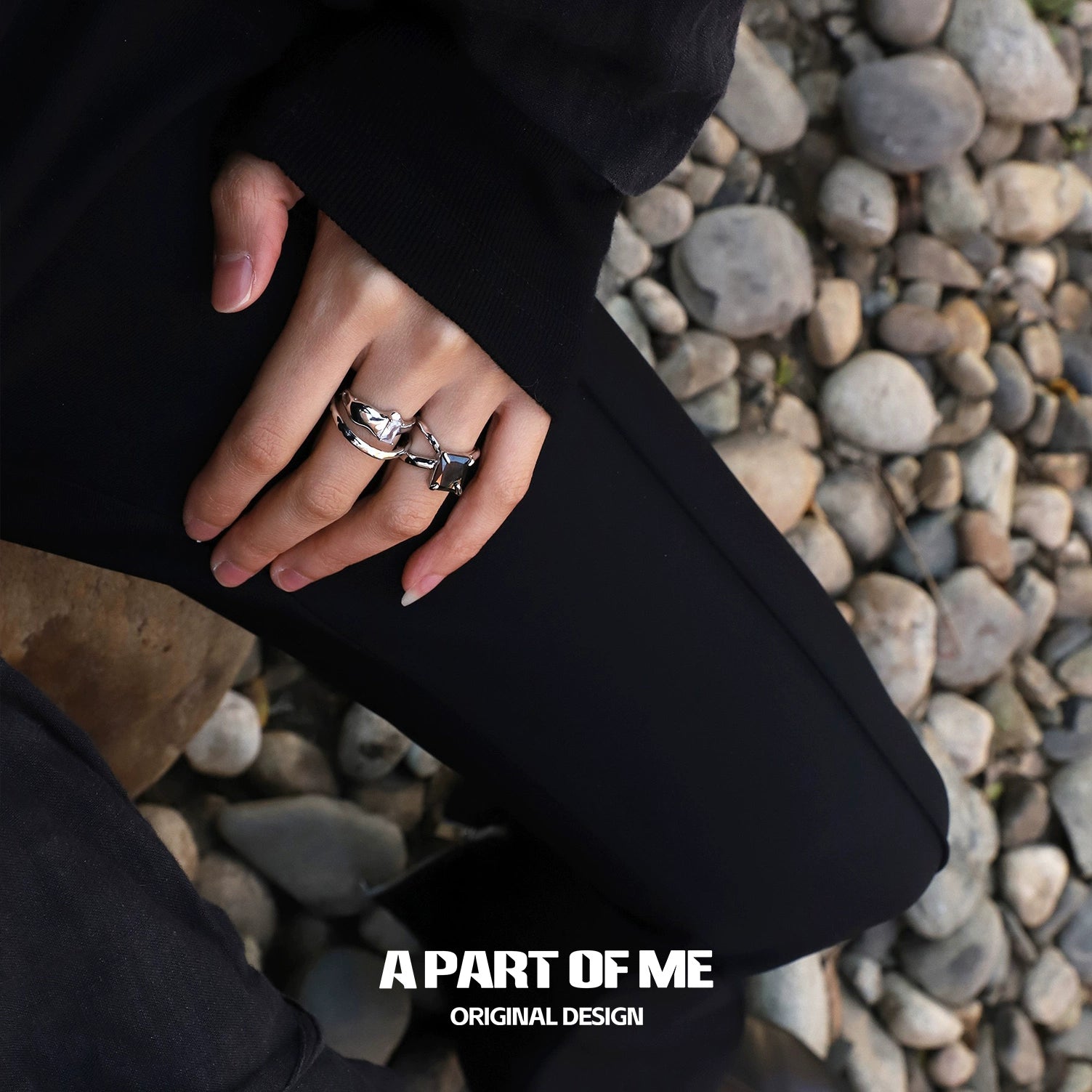 Stylish A PART OF ME savage claw hip-hop ring on a hand resting on stones