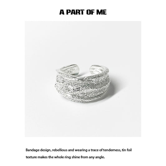 Silver bandage ring featuring a unique tin foil texture for a stylish and rebellious look