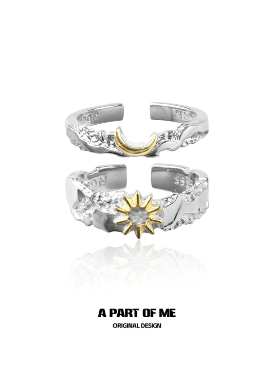 Silver sun and moon couple rings featuring a gold crescent moon and a gold sun design