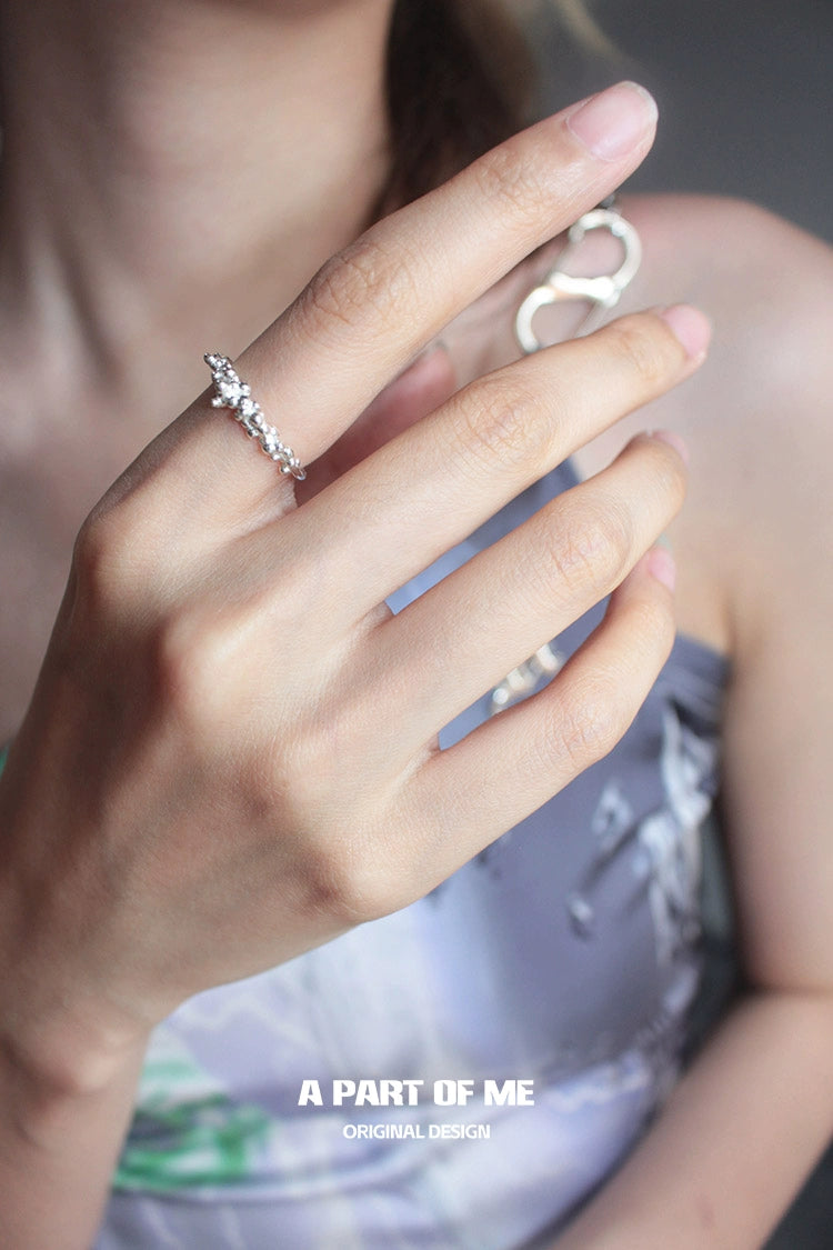A PART OF ME surf texture couple rings displayed on a hand, showcasing elegant design and craftsmanship