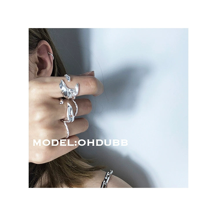 Stylish textured silver rings worn by a model showcasing elegant accessory designs
