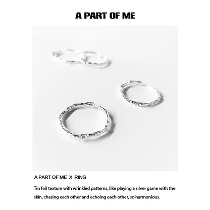 Textured silver rings with wrinkled patterns, showcasing a unique and harmonious design