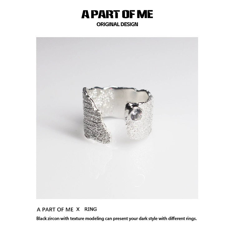 Textured silver travel ring from A PART OF ME showcasing a unique design with black zircon accents