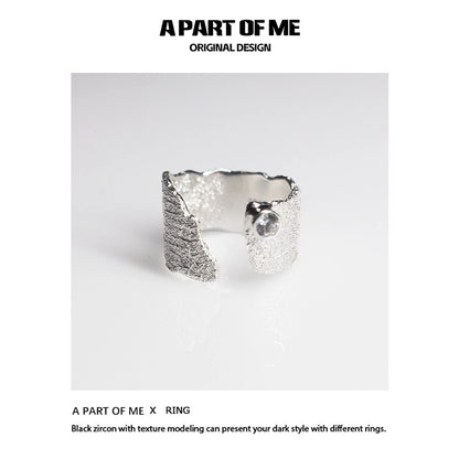 Textured silver travel ring from A PART OF ME showcasing a unique design with black zircon accents