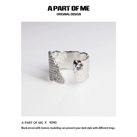 Textured silver travel ring from A PART OF ME showcasing a unique design with black zircon accents