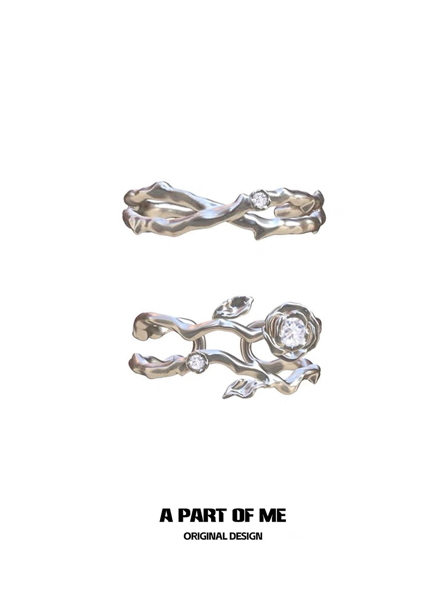 Thorned rose silver ring featuring intricate floral design and sparkling gemstones