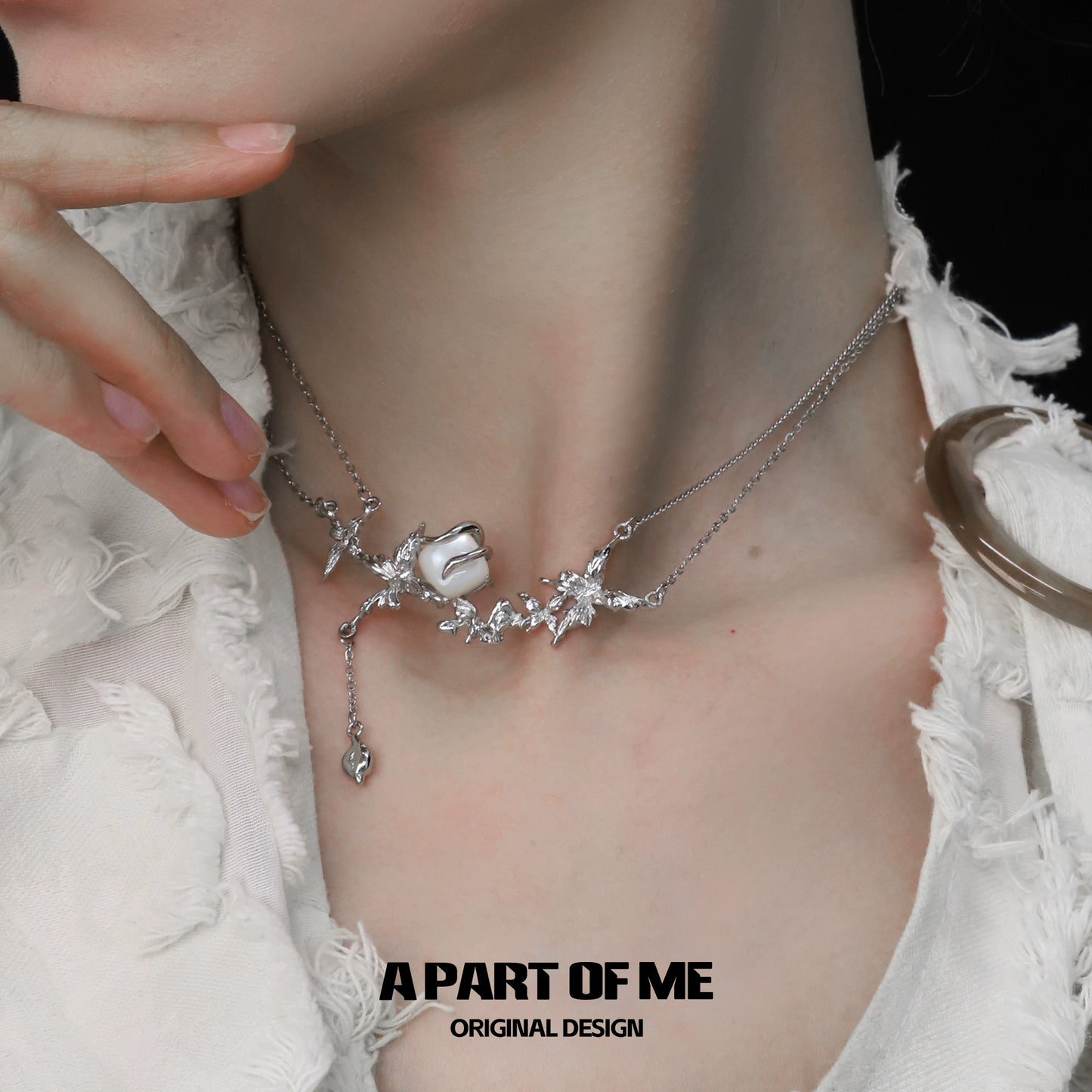 Elegant white butterfly shell necklace with intricate silver flowers, perfect for a stylish look