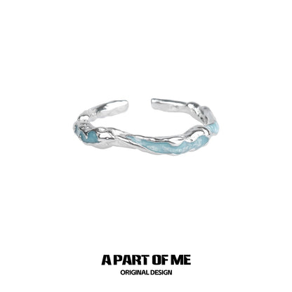 A PART OF ME White Orchid Love Ring with a unique twisted design and light blue accents
