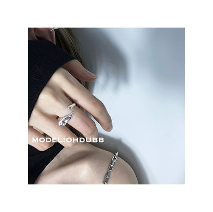 Y2K silver statement ring worn on a hand with a trendy outfit for a modern look
