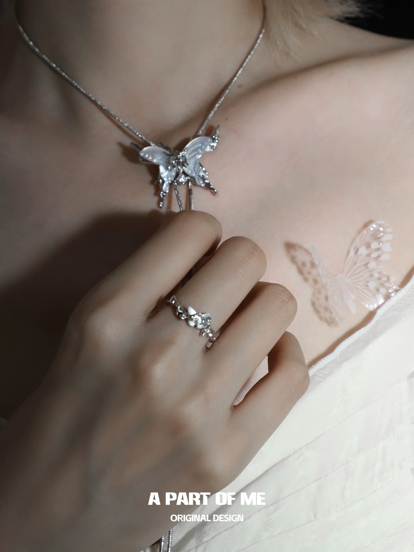 Elegant agate butterfly silver ring showcased on a hand, complementing a butterfly necklace