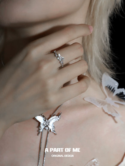Delicate agate butterfly silver ring with intricate design, worn on a model's hand