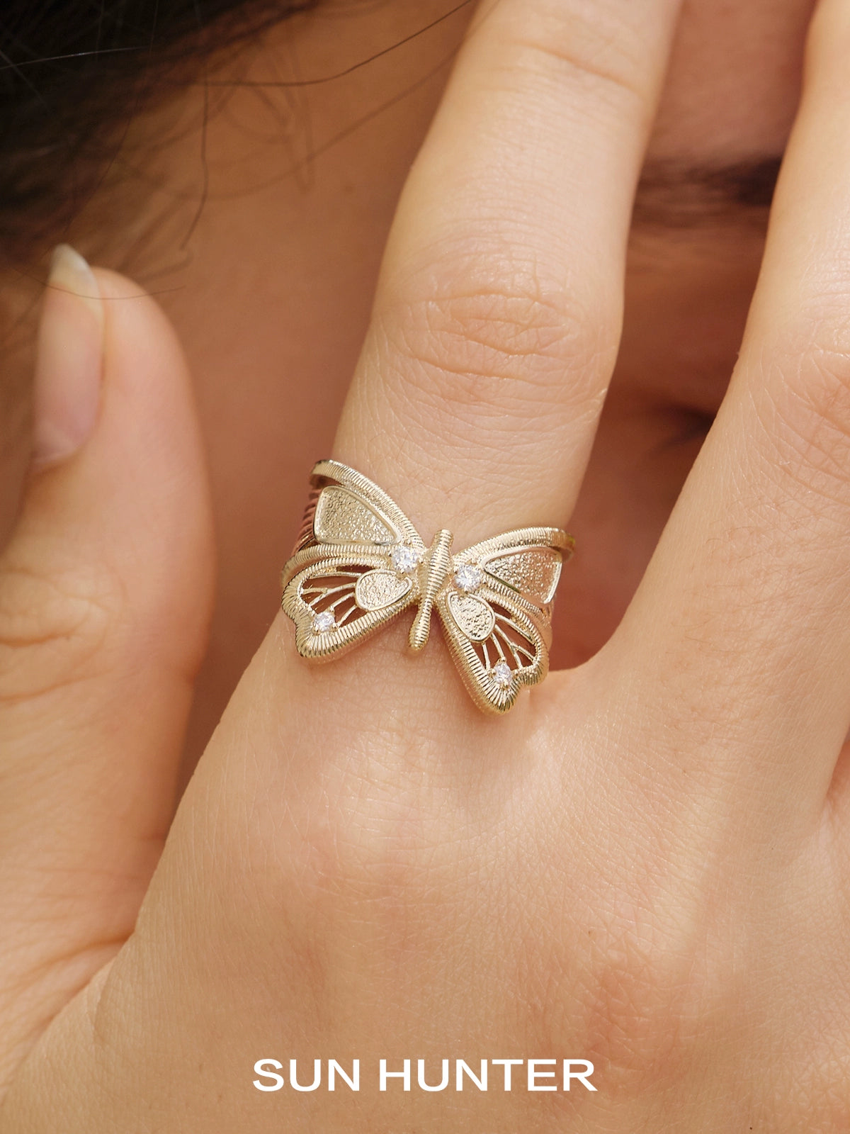 Elegant SUN HUNTER angel butterfly ring in gold with intricate detailing, perfect for stylish accessories