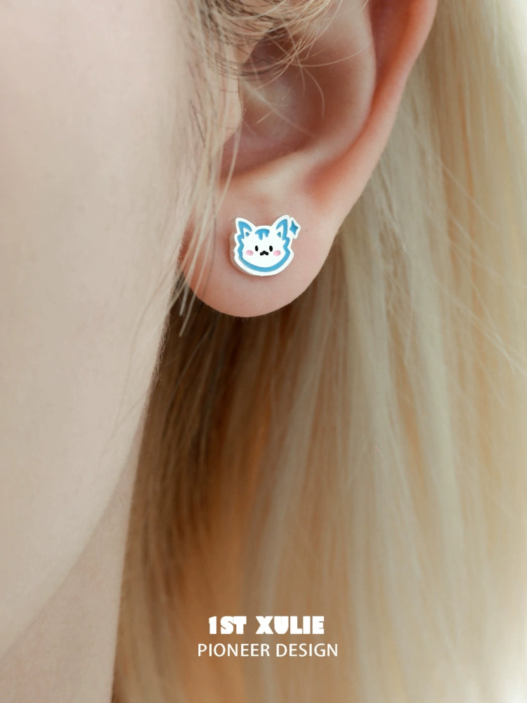 Cute angel cat and puppy earrings with colorful designs showcased on an earlobe