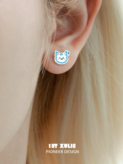 Cute angel cat and puppy earrings with colorful designs showcased on an earlobe