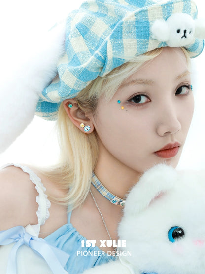 Angel cat paw print earrings styled with a blue checkered hat and soft plush toy