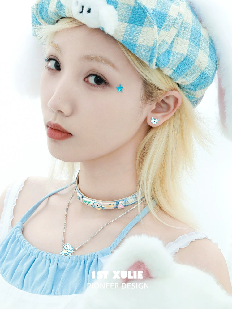 Woman wearing an angel cat puppy necklace along with cute accessories and a pastel outfit