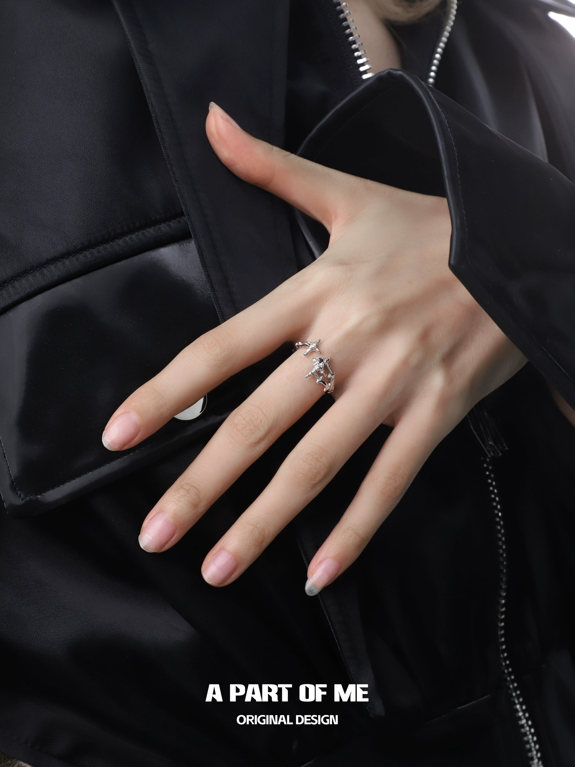 Elegant black and white starlight ring on a model’s hand, complementing a sleek outfit