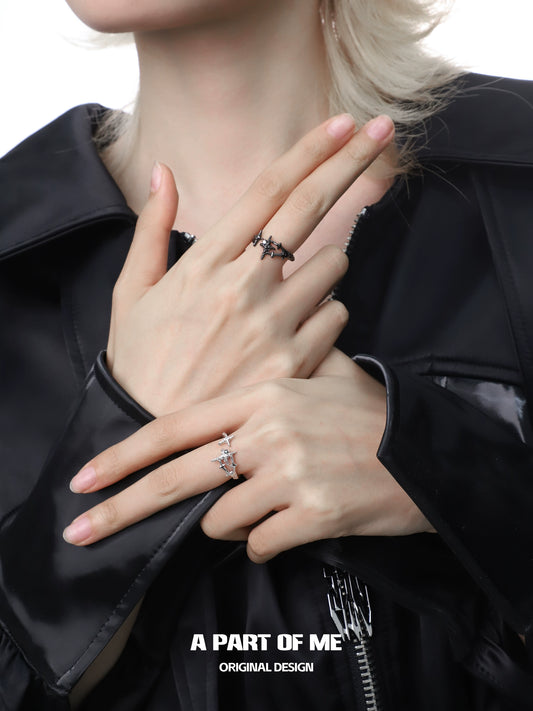 Elegant model showcasing a black and white starlight ring on delicate fingers