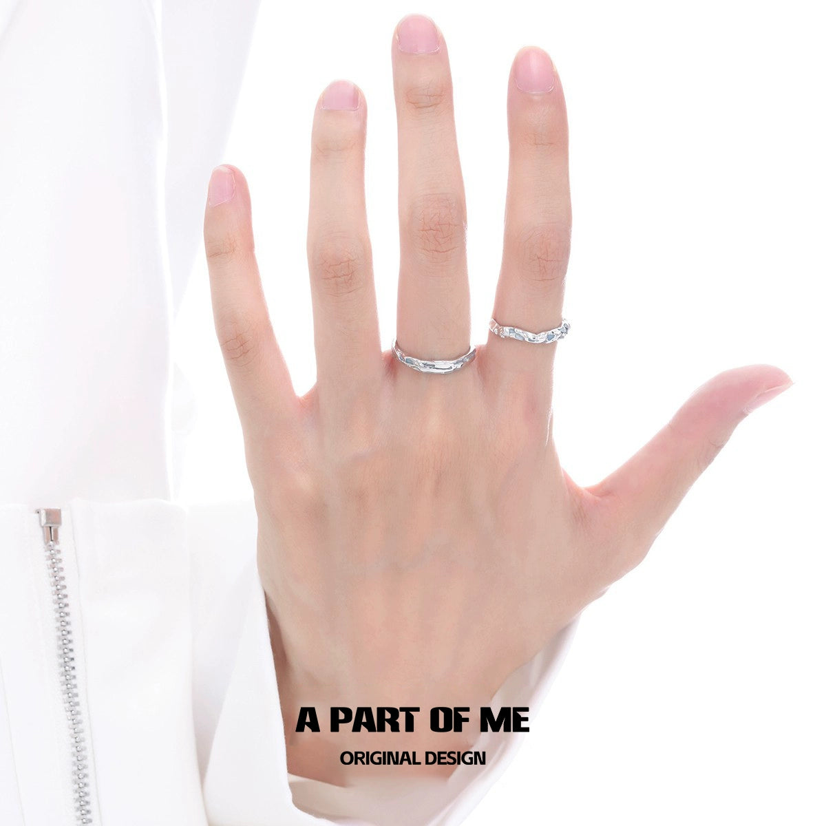 A hand wearing a blue slim statement ring alongside a silver band for stylish accessorizing