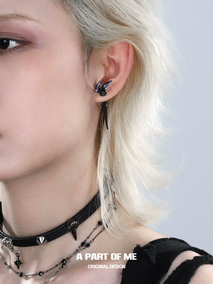 A PART OF ME fishtail dart sword earrings showcased on a model with edgy style