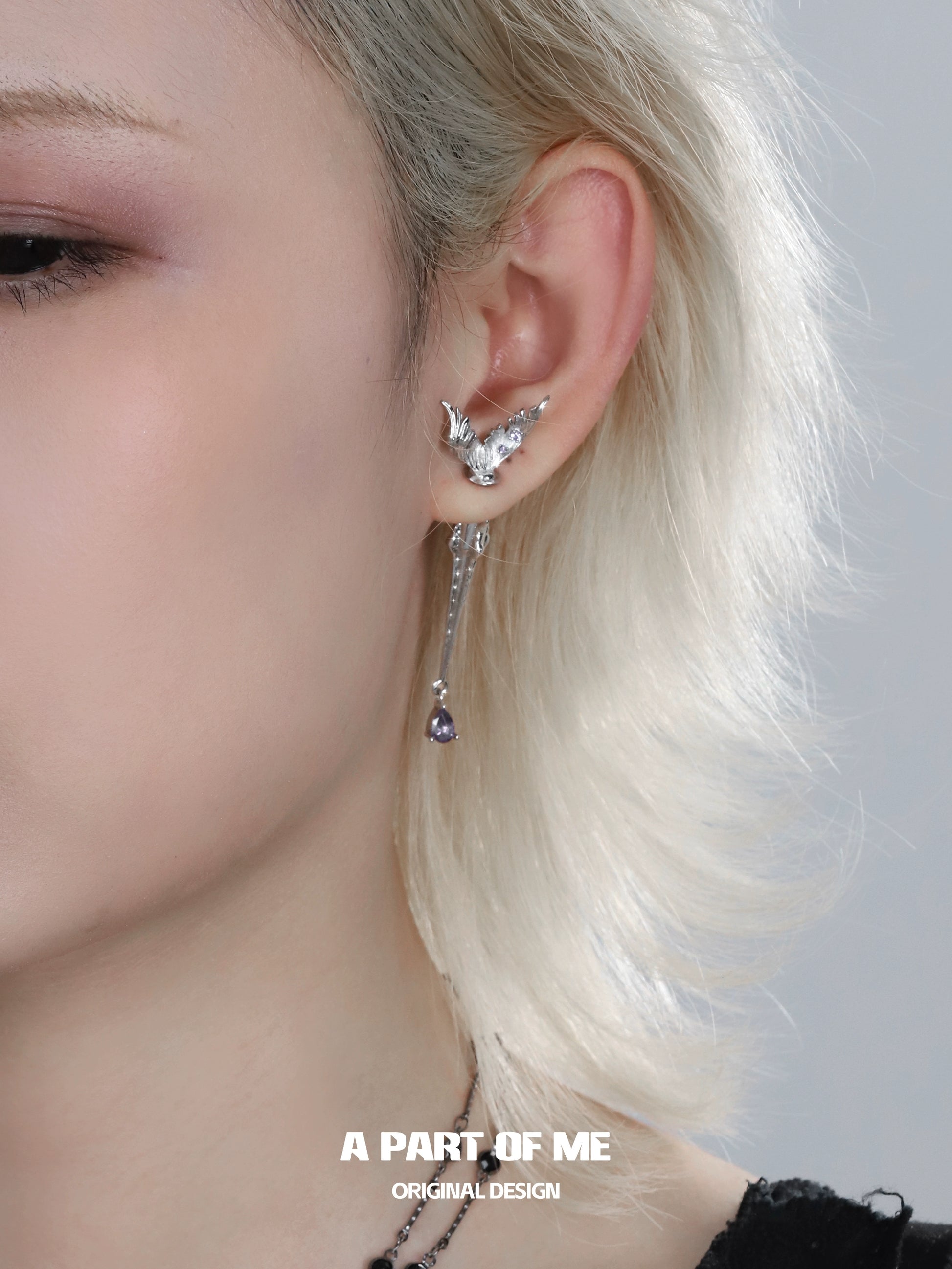 A PART OF ME fishtail dart sword earrings featuring a unique design with a dangling detail