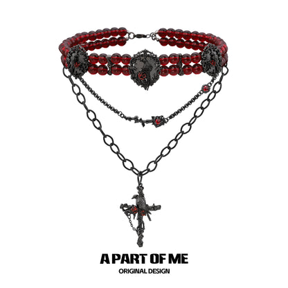 Gothic raven necklace featuring red beads and intricate black chain design from A PART OF ME