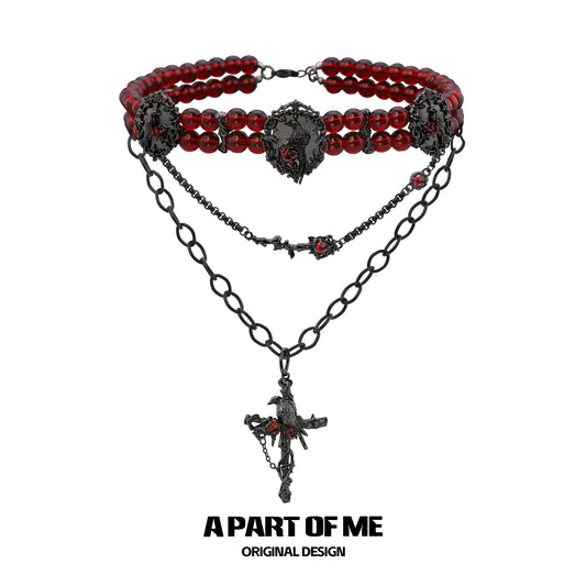 Gothic raven necklace featuring red beads and intricate black chain design from A PART OF ME